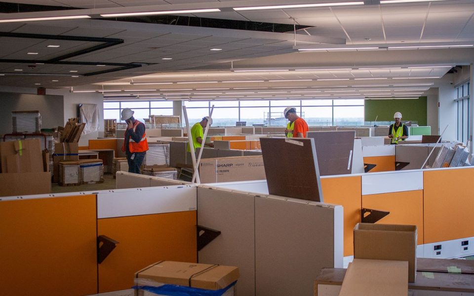 Workers Assemble Desks in Ash Brokerage Building